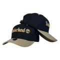 Gorra Timberland Negra con Visera Beige y Bordado en Relieve.