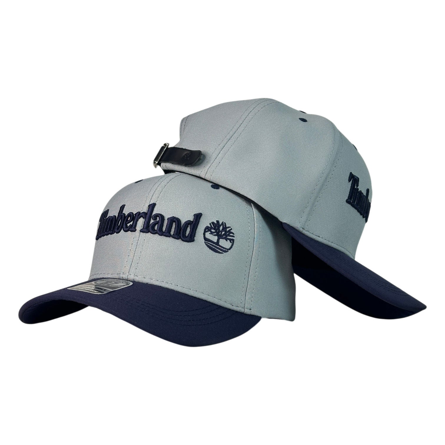 Gorra Timberland Gris con Visera Azul y Bordado en Relieve.